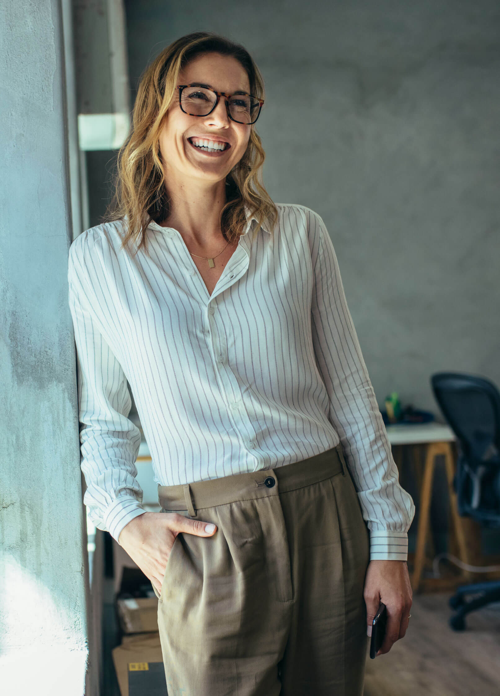 Woman with glasses leaning and smiling