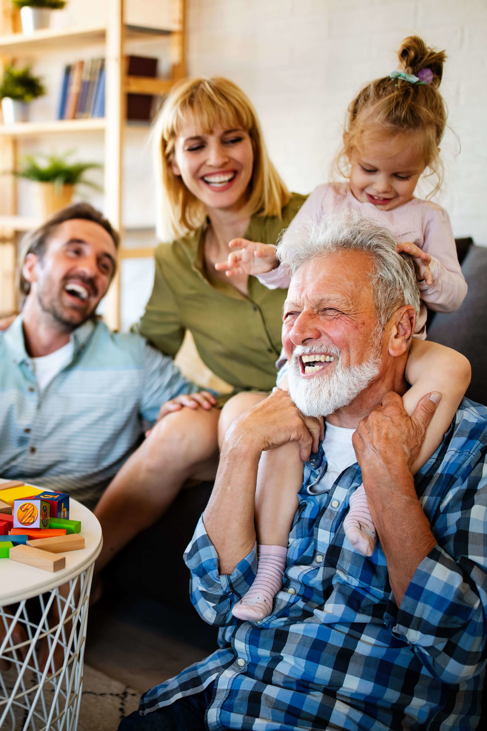 Happy family, child on grandfather's shoulders